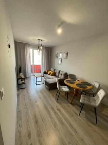 a living room with a couch and a table at Apartament Letnia 28 in Kłodzko