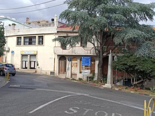 a stop sign in front of a white building at il telaio sardo Bonarcado in Bonarcado