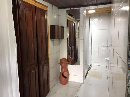 a bathroom with a toilet in the corner of a room at Pousada Alto Astral in Olinda