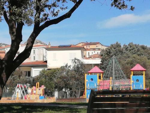 a park with a playground and a roller coaster at My Nest in Arzachena