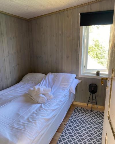 a small room with a bed with towels on it at Raaum Gard, hytte 2 in Hafslo