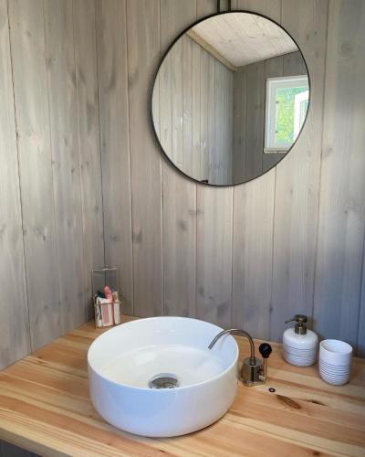 a bathroom with a white sink and a mirror at Raaum Gard, hytte 2 in Hafslo