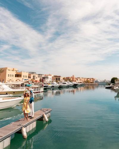 two people standing on a dock in a body of water at Turtle's Inn Hotel in Hurghada