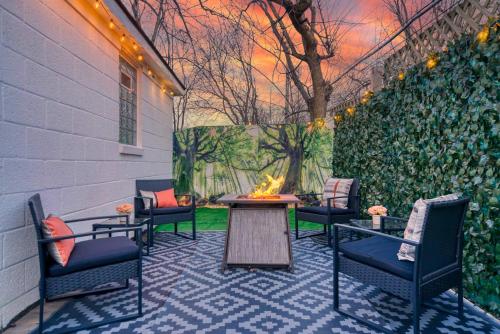 a patio with chairs and a table and a fire pit at Beautiful Modern home with all year use HOT TUB, Pool table, Game room, & Propane fire pit!! in Ferndale