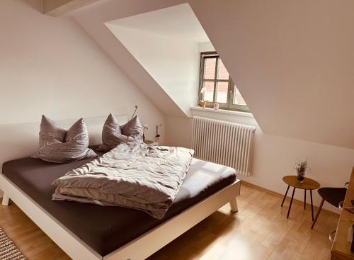 a bedroom with a bed with pillows on it at Apartment Altstadt Freiberg in Freiberg