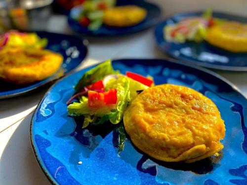 a blue plate with a sandwich and salad on it at Casa Rofo in Guanajuato