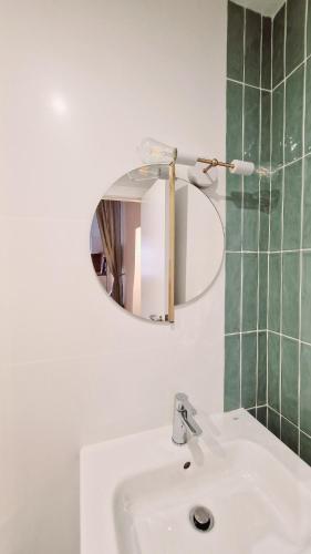 a bathroom with a white sink and a mirror at El 34 in Lorca