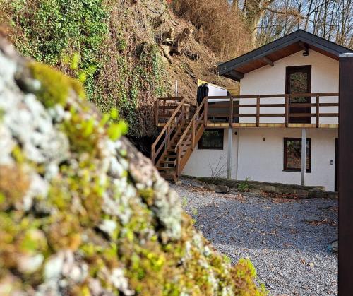 a small house with a wooden staircase in front of it at La cabane d'Achille - La Roche-en-Ardenne in La Roche-en-Ardenne