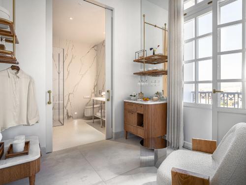 a bathroom with a wooden vanity and a mirror at The Dolli at Acropolis, A Hotel to Live in Athens