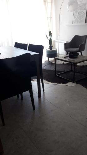 een woonkamer met een tafel en een stoel bij Villa Marija in Opatija