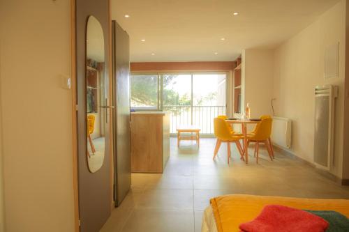 een woonkamer met een tafel en een eetkamer bij Magnifique appartement de type loft en front de mer avec vue, parking et WiFi in Argelès-sur-Mer
