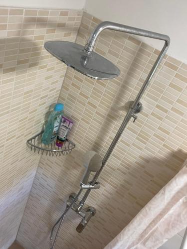 a shower with a shower head in a bathroom at Super Horizont beach house-FREE PARKING AND JACCUZZI in Split