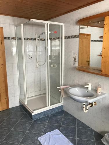 a bathroom with a shower and a sink at Pension Max Schraml in Grundlsee