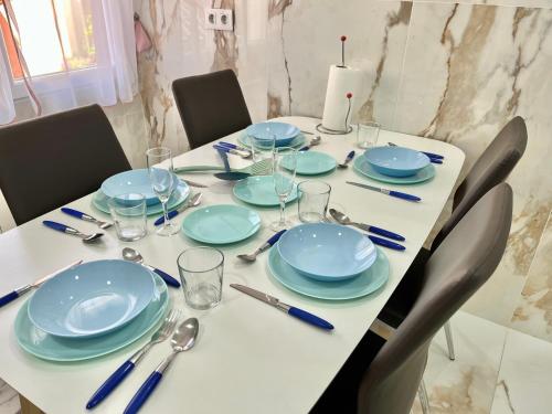 a table with blue plates and silverware on it at In Love Zamora in Zamora