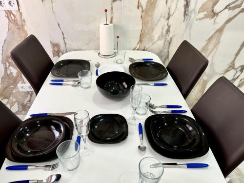 a table with black plates and wine glasses on it at In Love Zamora in Zamora