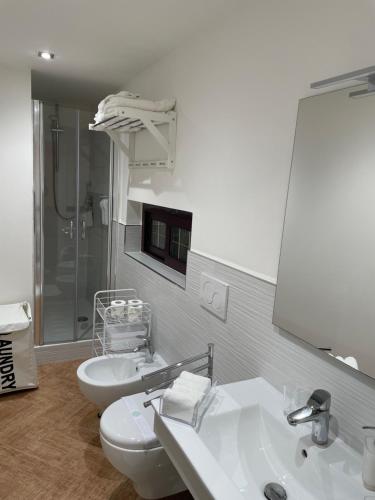 a bathroom with two white sinks and a shower at Lamezia Park Apartments in Lamezia Terme