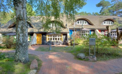 a house with a tree in front of it at Ferienhaus Wolters in Ostseebad Karlshagen