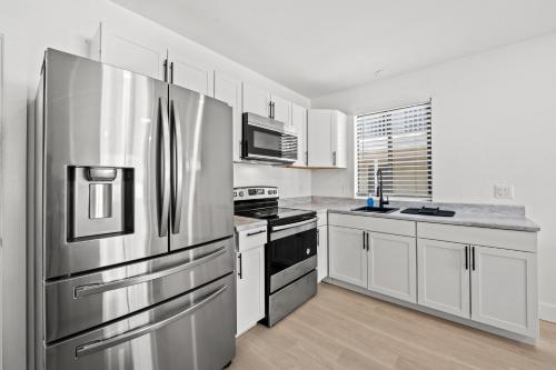 a kitchen with stainless steel appliances and white cabinets at Serendipity in Myrtle Beach