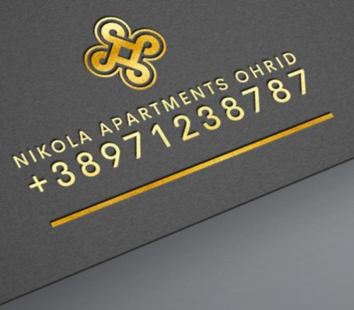 una tarjeta de monopolio con una cruz de oro encima en Apartment NIKOLA ORANGE, en Ohrid