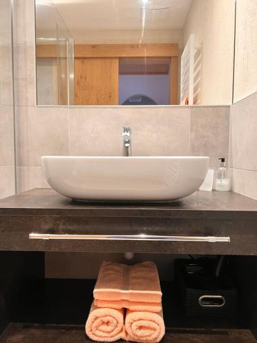 a bathroom counter with a sink and a towel at Aclavaldafur Apart in Nauders