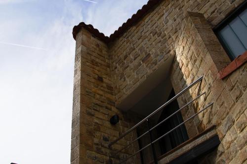 a brick building with a staircase on it at La Jarocha, casa con vistas al mar en Pechón in Pechón