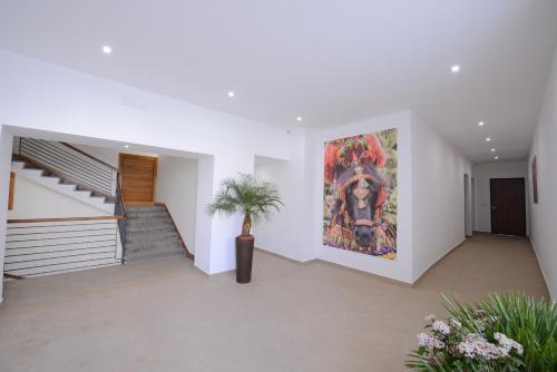 a hallway with a staircase and a painting on the wall at Residence Rapisardi by RECEPTIO in Catania