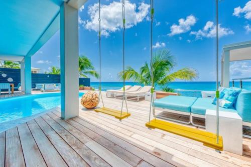 a villa with a view of the ocean at Surfsong Villa- Luxury Water Front Villa for 12 in Maho Reef