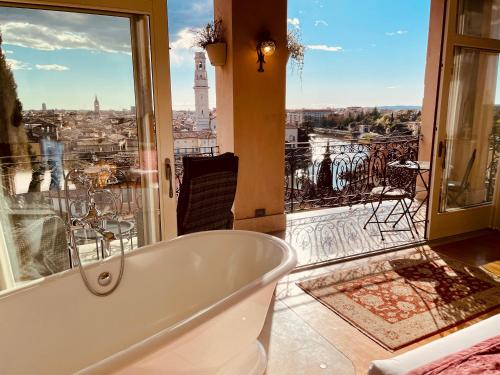 a bath tub in a bathroom with a view of the city at Relais Colle San Pietro in Verona