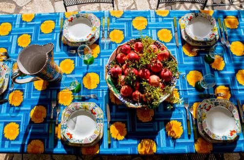 a blue table with a bowl of fruit on it at Capri Villa Vittoria by Capri Property in Anacapri