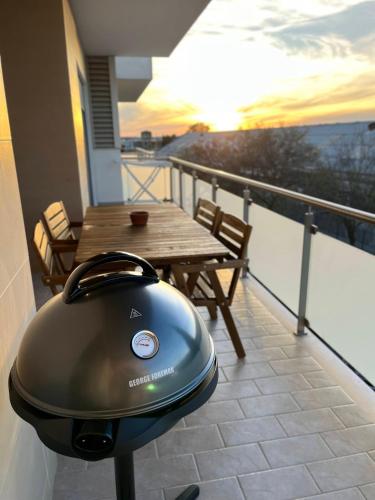 a grill sitting on top of a balcony with a table at Rias Apart II in Vila Real de Santo António