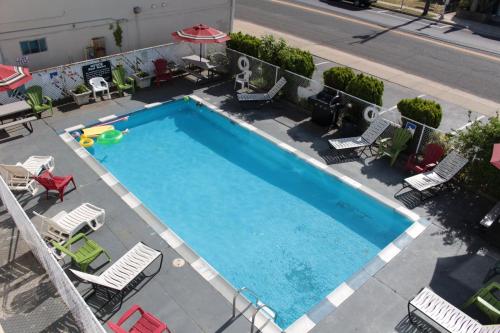 an overhead view of a large swimming pool with chairs and umbrellas at Jersey Shore 1 & 3 Bedroom Premium Beach House in Seaside Heights