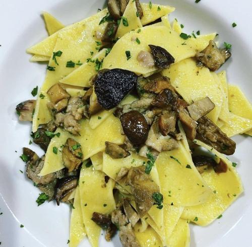 a plate of ravioli with mushrooms and nuts at Agriturismo Eco-Bio Villa Vacasio in Pitigliano