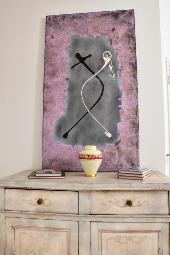 a painting of a clock on top of a dresser at Avanguardia Art Club in Ferrara