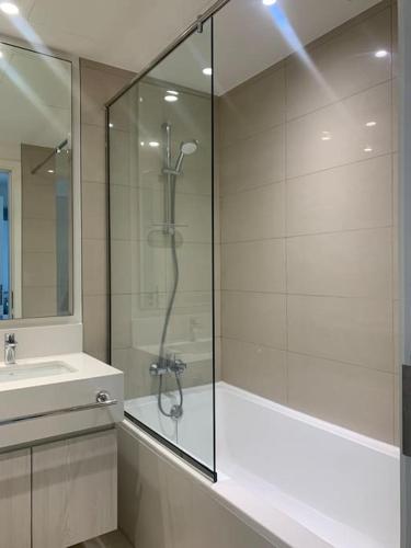 a bathroom with a shower and a sink at Enjoy a Modern and Trendy apartment in the Heart of Dubai in Dubai