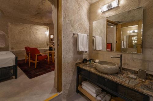 a bathroom with a sink and a mirror at The Niche Cave Hotel in Goreme