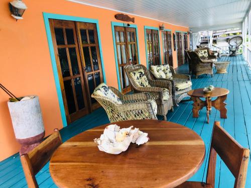 a room with a wooden table and chairs at Coral Cove Inn in Maya Beach