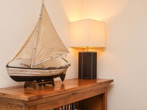 a model of a sail boat on a book shelf at Chandler's View in Whitby