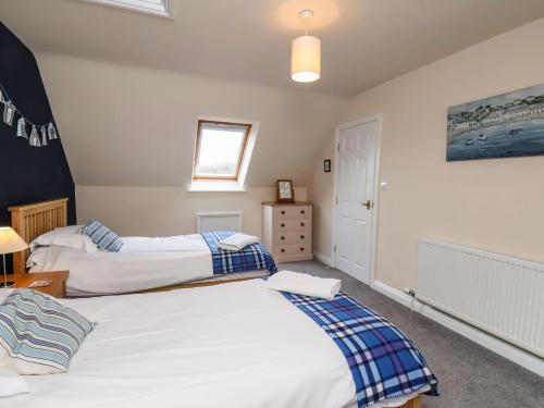 a bedroom with two beds and a window at Chandler's View in Whitby