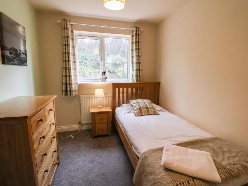 a small bedroom with a bed and a window at Chandler's View in Whitby