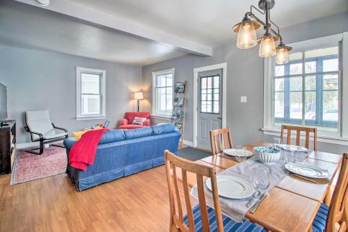 a living room with a blue couch and a table at Aurora Outdoorsy Getaway with Deck and Grill! in Biwabik