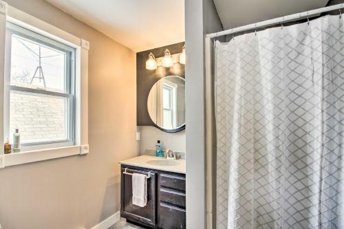 a bathroom with a shower with a sink and a window at Aurora Outdoorsy Getaway with Deck and Grill! in Biwabik