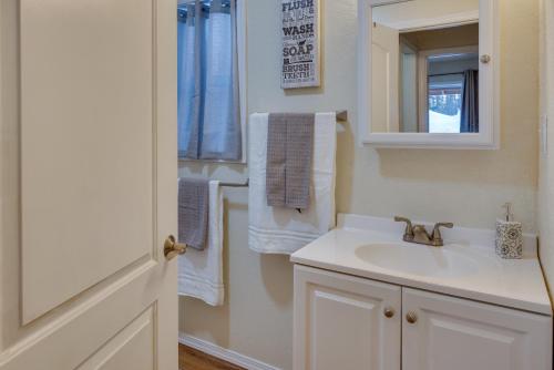 a bathroom with a sink and a mirror and towels at Soldotna Vacation Rental about 8 Mi to Kenai River! in Soldotna