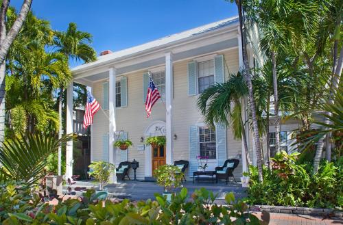 a white house with two american flags on it at Westwinds Inn in Key West