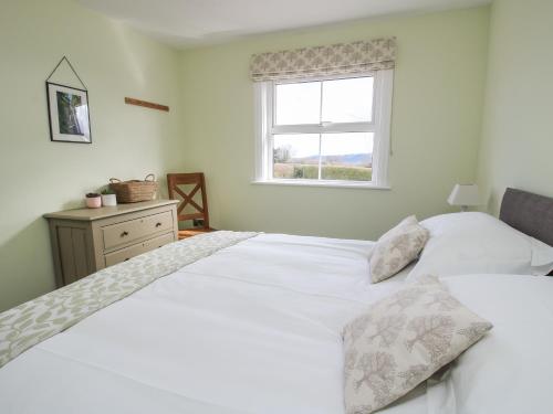 two beds in a bedroom with a window at Bethania in Oswestry