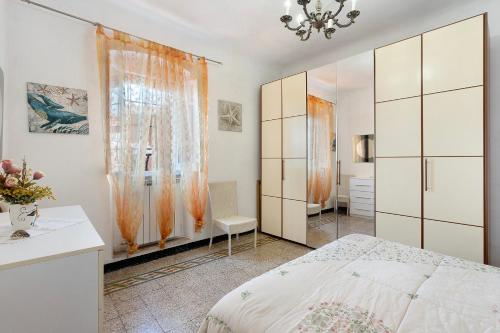 a white bedroom with a bed and a room at Dalla Ire in Lerici