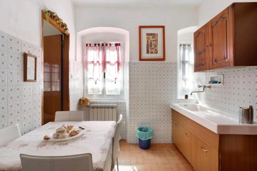 a small kitchen with a table and a sink at Dalla Ire in Lerici