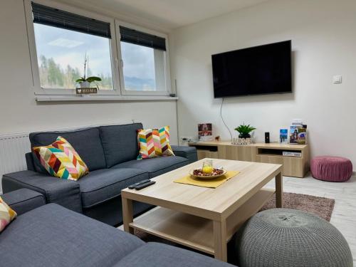 a living room with a couch and a table at Apartmán Pantáreň in Čadca