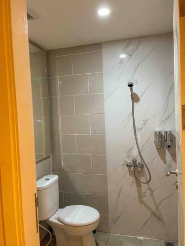a bathroom with a toilet and a shower at Luxury Modern La Casa Benson in Lontar