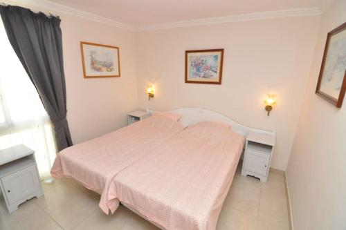 1 dormitorio con 1 cama grande con manta rosa en Apartment in Las Plataneras, en Los Cristianos