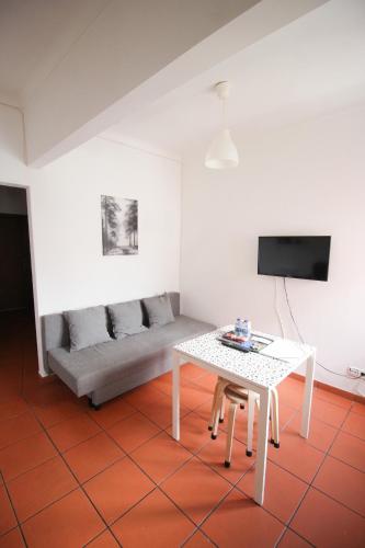 a living room with a table and a couch at Oriente DNA Studios VI in Lisbon